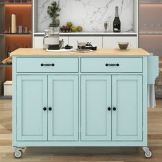 a blue kitchen island with two wine bottles on top and an open shelf above it