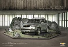 an advertisement for the chevrolet suv is shown in front of some rocks and boulders with trees on them