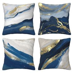 four blue and white pillows with gold foil designs on the front, two in the back and one in the middle