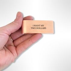 hand holding copper money clip with black text Dollars Money, Money For Nothing, Cream Cat, Work Smarter Not Harder, Two Dollars, Smarter Not Harder, Text Overlay, The Fold, Work Smarter