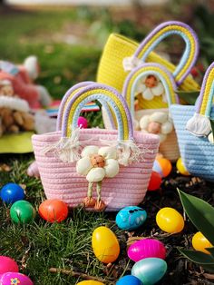 colorful baskets and easter eggs on the ground in front of some grass with stuffed animals