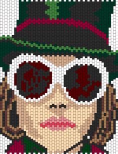 a cross stitch image of a woman wearing glasses and a green hat with red flowers on it