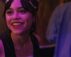 a young woman smiling and wearing a headband