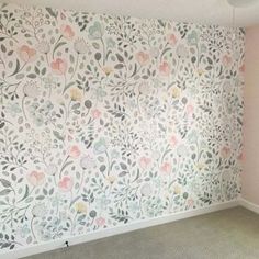 an empty room with floral wallpaper on the walls and carpet in front of it