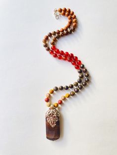 I make my own decisions with confidence and conviction. I allow my creativity to flow through me freely. I am confident in my ability to succeed. My sacral chakra is balanced. This purchase includes: Gemstone Half Mala, baggie, card including using your mala, intention setting and properties. GEMSTONES Rudraksha: Rudraksha seeds grow inside of what look like blueberries on trees in South East Asia. In Buddhism and Hinduism, the beads are believed to provide inner calm, peace, and free one from n Earthy Agate Beaded Necklaces With Natural Stones, Long Healing Necklace With Natural Stones, Nature-inspired Agate Beaded Necklace With Natural Stones, Earthy Natural Stone Jewelry, Holistic Jewelry With 108 Beads For Rituals, Artisan Jewelry With 108 Beads As Gift, Brown Gemstone Beads Nature-inspired Necklace, Artisan Jewelry With 108 Beads Gift, Earthy Amber Necklace With Natural Stones