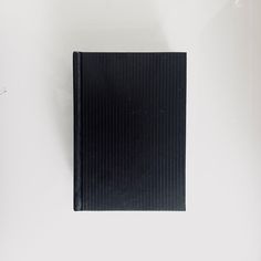 a black book sitting on top of a white table