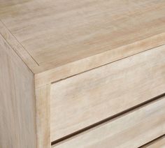 a close up of a wooden dresser with two drawers on each side and one drawer at the top