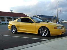 a yellow sports car parked in a parking lot