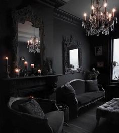 a living room filled with furniture and chandelier above a window covered in candles