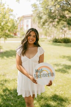 a woman holding a white frisbee that says mrs renteria in front of her