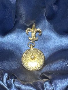 This vintage locket from Coro is a unique find for any jewelry collector. The locket features a beautiful fleur de lis design and can hold two pictures. This piece is signed and dates back to the 1940s. It would make a great addition to any vintage or antique jewelry collection. The locket is in good condition and shows minimal signs of wear. Perfect for gifting or adding to your personal collection. FYI: We have been in pastoral ministry for over 40 years, the goal of selling any items on 'powers-gems' is to support children's ministries in Honduras and other nations where children are being taken from living in the city garbage dumps, educated, feed and clothed by Godly people to give them a future with hope and purpose. Join us:) Antique Charms Locket Necklace For Keepsake, Classic Vintage Charm Locket Necklace Collectible, Vintage Yellow Gold Locket Necklace For Keepsake, Heirloom Round Pendant Locket Necklace, Heirloom Collectible Round Pendant Locket Necklace, Vintage Yellow Gold Locket Necklace For Memorial, Vintage Yellow Gold Memorial Locket Necklace, Vintage Keepsake Charms Jewelry, Vintage Keepsake Jewelry With Charms