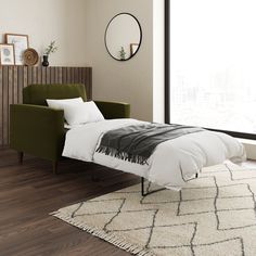 a bed sitting on top of a wooden floor next to a green chair and window