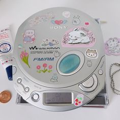 an electronic device with many stickers on the front and back cover, along with other items