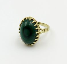 Originally,  $975.00. Circa 1950.  Gorgeous green Malachite oval cabochon prong set in 14kt gold. The beautiful circular banding and richness of the green stone is further enhanced by the detailed prong setting and gallery.   The the top/setting measures approximately 19mm x 13mm The ring is stamped "585" for 14KT gold.  There is a hallmark or makers mark with two letter "H" with an overlapping "C". The ring is a size 7 1/4 and can be sized. Customer Care:  I will help guide you throughout the e Green Oval Dome Ring For Formal Occasions, Formal Oval Cabochon Emerald Ring, Vintage Oval Cabochons For Formal Occasions, Formal Emerald Cabochon Ring, Heirloom Oval Green Ring, Formal Vintage Emerald Ring With Oval Cabochon, Heirloom Style Emerald Ring With Cabochon Cut, Timeless Oval Emerald Ring With Polished Finish, Antique Green Emerald Ring With Polished Finish