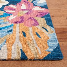 a blue rug with pink flowers on it