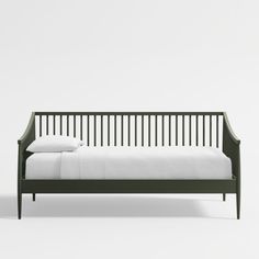 the bed is made up with white sheets and black wood slatted headboard