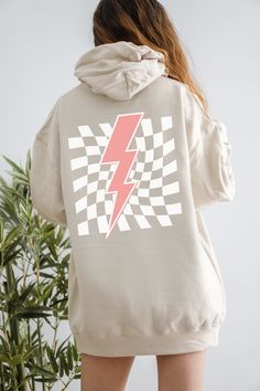 Get Obsessed with the Checkered Aesthetic with this cute Lightning Bolt Hoodie! This Preppy Hoodie is super comfy! Size up for a Trendy Oversized Look! ♥ Hello and Welcome to Meaningful Tees Shop! ♥ Printed on the most popular Unisex Hoodie, the Gildan 18500 is 50% Cotton / 50% Poly. The soft fleece lining makes it super Comfy and is sure to become your new favorite! ♥ All of our items are made to order with care for each customer : ) ♥ Please allow 3-7 BUSINESS days (usually 3-5) for your item to be created PLUS shipping time via USPS ♥ This Unisex Hoodie fits like a Men's on Women, but is not overly large. ♥ For a RELAXED FIT, your usual size will typically work, but please consult the Size Chart in the Listing Photos ♥ For an OVERSIZED FIT, size up 1, 2, or 3 Sizes! (2 sizes up is the m Trendy Hooded Hoodie With Graphic Print, Trendy Graphic Print Hooded Hoodie, Trendy Crew Neck Sweatshirt With Drawstring Hood, Trendy Hoodie With Kangaroo Pocket And Crew Neck, Trendy Graphic Print Hoodie Sweatshirt, Trendy Crew Neck Hoodie With Kangaroo Pocket, Cute Lightning Bolt, Checkered Aesthetic, Preppy Hoodie