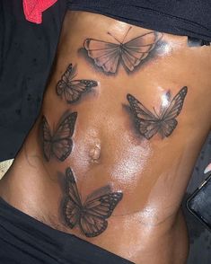 a woman's stomach with butterflies on it