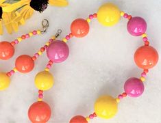 "30\" Brite Bubble Beaded Orange/Pink/Yellow Multi Lucite Necklace & Matching Cluster Clip On Earrings Pink/Yellow/Orange Alternating Beads with Mini Beads Large Beads Measure 3/4\" in Diameter Smaller Beads Measure 5/8\" in Diameter Silver Tone Lobster Clasp Cluster Clip On Earrings Measure 1 1/8\" in Diameter Made in USA Necklace/Earrings Set 42.00 Necklace Only 29.00 Cluster Earrings Only 15.00 COMPLIMENTARY DOMESTIC SHIPPING" Yellow Round Bead Necklaces For Summer, Yellow Round Beads Necklace For Summer, Yellow Beaded Necklaces With Round Beads For Summer, Yellow Beaded Necklaces With Large Beads For Summer, Yellow Beaded Necklaces For Summer, Summer Yellow Beaded Necklaces With Large Beads, Adjustable Single Strand Yellow Beaded Necklaces, Adjustable Single Strand Yellow Beaded Necklace, Adjustable Yellow Single Strand Beaded Necklaces