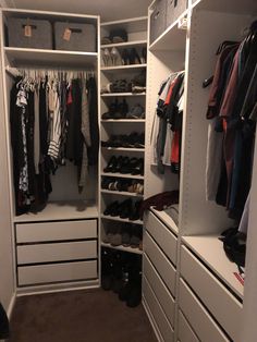 an organized closet with white drawers and shelves