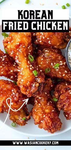 chicken wings with sesame seeds and rice on a white plate that says korean fried chicken