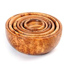 a wooden bowl filled with lots of different types of wood rings on top of each other