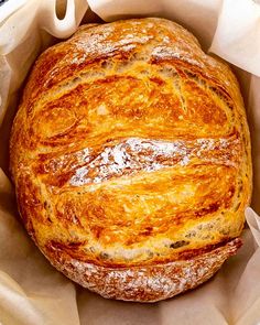 a loaf of bread sitting inside of a paper bag