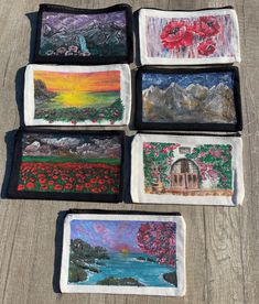 four small bags with paintings on them sitting on a table