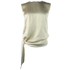 Product details: The top made of 100% silk in cream/ ivory color, sleeveless with crew neck line and size tie detail designed by Celine in Paris. It closures with rear zip and hook. Cream Silk Blouse, Black Drapes, Phoebe Philo, Cream Silk, Virtual Stylist, Luxury Silk, Silk Shorts, Long Sleeve Knit Tops, Gianni Versace