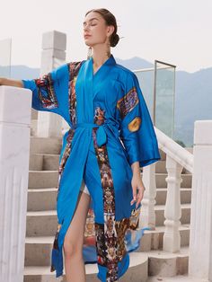 Crafted with meticulous attention to detail, our kimono robe embodies the essence of Eastern luxury, offering you a truly indulgent experience every time you slip it on. Its versatile design effortlessly transitions from leisurely mornings to elegant evenings, ensuring you stay poised and refined throughout the day.• Silky Comfort: Made of high-quality polyester charmeuse, our robes are soft, lightweight and cooling for summer. They have a smooth and breathable texture that feels just like natur Luxury Long Sleeve Robe For Spring, Luxury Long Sleeve Spring Robe, Elegant Wrap Robe For Vacation, Luxury Long Silk Kimono, Blue Summer Robe With Kimono Sleeves, Blue Silk Kimono For Vacation, Blue Kimono Sleeve Robe For Summer, Blue Robe With Kimono Sleeves For Summer, Elegant Long Robe For Vacation