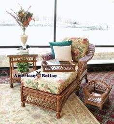 a living room with wicker furniture and large windows overlooking the snow - covered lake