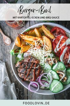 a white bowl filled with meat and veggies on top of a wooden table