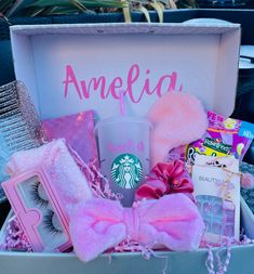 a pink gift box filled with personal care items