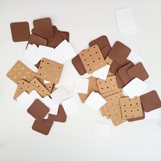 several pieces of brown and white paper with holes cut out to look like ice cream sandwiches