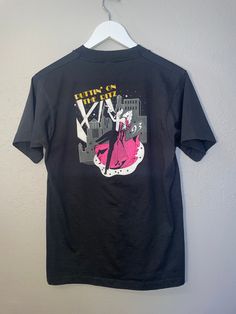 "puttin on  the Ritz 1983 Buddy Austin international Oklahoma City T-shirt Condition: GOOD  measurements: 34\" bust/chest, 27\" length material: cotton/polyester" Fitted Concert T-shirt With Graphic Print, Fitted Graphic T-shirt For Concerts, Fitted Graphic Print T-shirt For Concert, 90s Style Concert T-shirt With Screen Print, Fitted Pop Culture T-shirt For Streetwear, Fitted Graphic Print T-shirt For Fan Merchandise, Fitted Graphic Print T-shirt For Fans, Fitted Screen Print T-shirt For Concerts, Vintage Graphic T-shirt For Concerts