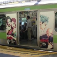 a subway car with advertisements on the side