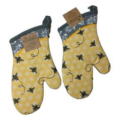 two oven mitts with bees and honeycombs on them, one is yellow