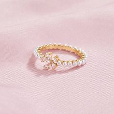 Complete any look with this beautifully crafted Maisie Crystal & Pearl Flower Ring. Designed to sparkle and shine all night long, this ring is perfect for any occasion. 18K gold plated, brass AAA cubic zirconia crystal Imitation freshwater pearl Hypoallergenic, lead & nickel free US/Canada Ring Size UK/AU Ring Size Inside Diameter (mm) 6 L 16.6mm 7 N 17.2mm 8 P 18.1mm If you aren't in LOVE with your purchase, please let us know within 30 days of receiving your item, and you'll receive a stress-f Elegant Gold-plated Flower Ring, Gold Cubic Zirconia Diamond Ring With Sparkling Detail, Elegant Yellow Gold Cubic Zirconia Flower Ring, Delicate Gold Rings For Party, Gold Sparkling Rings For Wedding, Elegant Gold Plated Flower Ring For Wedding, Sparkling Gold Rings For Wedding, Elegant Gold Flower Ring For Party, Delicate Gold Party Rings