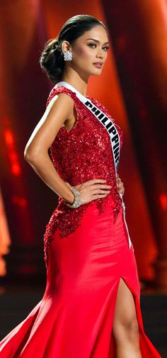 a beautiful woman in a red gown on stage