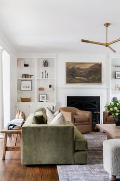 a living room filled with furniture and a fire place