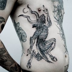 a man with some tattoos on his stomach