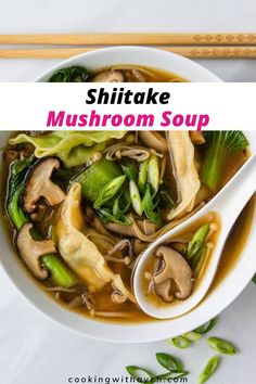 a white bowl filled with mushroom soup next to chopsticks