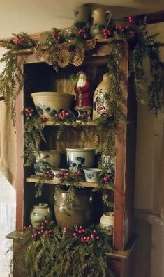 an old wooden shelf with christmas decorations on it