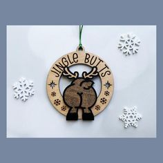 a wooden ornament hanging on a wall with snowflakes and ornaments around it