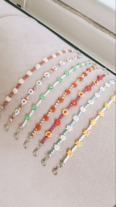 the beaded bracelets are lined up on the edge of a window sill