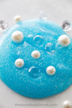 a blue cake with white pearls on it