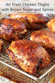 several pieces of chicken sitting on a metal pan with grate in the bottom half