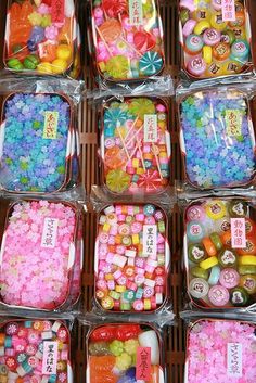 many different types of candies in plastic containers