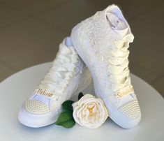 There are many great benefits to wearing sneakers with your wedding dress - the most obvious is comfort. With a comfortable pair of tennis shoes on your feet, you will not have to avoid the track, you can easily do the laps at your reception and you will not wake up in the morning with unwanted blisters. The ivory lace with pearls in this dreamy couple is 100% worthy of a wedding. SIZE: Tip..  Its size Converse is smaller than other companies (eg. if you Nike wear 40, wear Converse 39) ★If you h Cream Wedding Shoes With White Laces, White Sneakers With Laces For Bridal Shower, White Low-top Bridal Sneakers, White High-top Sneakers For Wedding, White Round Toe Sneakers For Bridal Shower, White Low-top Wedding Shoes, White Lace-up Wedding Shoes With White Laces, White Lace-up Wedding Shoes, White Lace-up Wedding Shoes For Bridal Shower