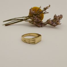 Unique Engraved 14K / 18K Solid Gold Signet Ring for Men and Women Handmade of Yellow / White / Rose Gold. Shaped as a classic rectangle signet ring with simple straight edges and engraved with two lotus flowers blooming on the sides of the ring. It has a simple straight rectangle shape held and embraced by two flowers. This ring is very unique and has a strong presence, it captures a flowing pattern within a geometric frame. It is made by hand out of wax inspired by the endless beauty of nature Heirloom Rectangular Signet Ring Stamped 14k, Modern Gold Rings With Engraving Option, Rectangular Signet Ring As Fine Jewelry Gift, Luxury 14k Gold Rectangular Signet Ring, Luxury Rectangular 14k Gold Signet Ring, Timeless Rectangular Signet Ring For Gift, Heirloom Yellow Gold Signet Ring In Recycled Gold, Rectangular 14k Gold Signet Ring, Rectangular 14k Gold Signet Ring Gift